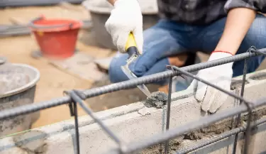 bricklayer-worker-installing-brick-masonry-on-exterior-wall-with-trowel-putty-kn