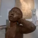 Cuadros a baja altura, mesas bajas y almohadones en una muestra dedicada a las infancias